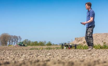 Man bestuurt drone op een landbouwgrond